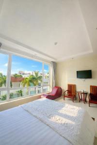 En eller flere senge i et værelse på Mio Hotel Vũng Tàu