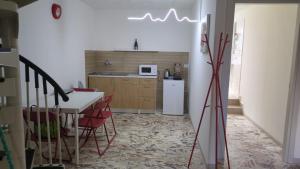 a kitchen and dining room with a table and chairs at Domus Battisti in Caserta