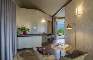 a kitchen and living room with a table and chairs at Tresort Oil Glamping in Principina Terra