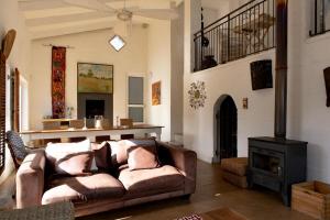 a living room with a couch and a stove at Joan's Sea Cottage in Pringle Bay