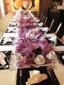 a long table with a purple table cloth on it at Hotel Blick in Gdynia