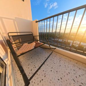 a room with a bed on a balcony with a view at Eden Living - Cebu in Lapu Lapu City