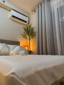 a bedroom with a bed and a window with curtains at Eden Living - Cebu in Lapu Lapu City +22 photos