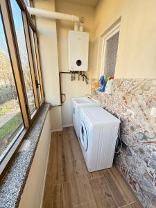 a laundry room with a washer and dryer at Casa Lorà in Pistoia +2 photos