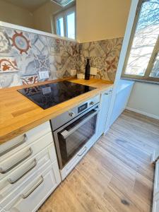 a kitchen with white cabinets and a wooden counter top at Casa Lorà in Pistoia