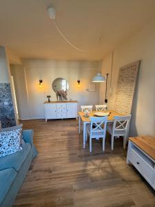 a living room with a table and a blue couch at Casa Lorà in Pistoia