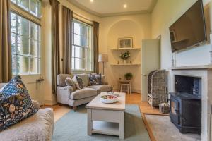 a living room with a couch and a fireplace at Bath Lodge in Bristol