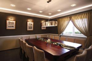 a dining room with a wooden table and chairs at Hotel Pod Złotą Koroną in Opole