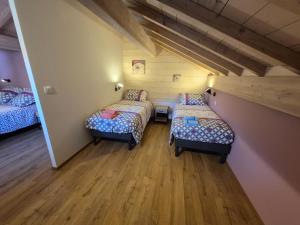 a room with three beds in a room at Maison Gite Le Randonneur in La Bresse