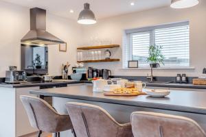 a kitchen with a large counter top with chairs at 4 Bed in Pleasley Vale oc-c30857 in Mansfield Woodhouse