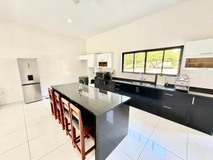 a large kitchen with a large black counter top at Amuji Accommodation and Apartments in Vilanculos