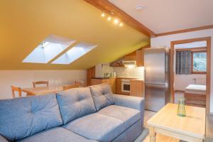a living room with a blue couch and a kitchen at Lakeside Apartments in Haller