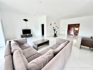 a large living room with a couch and a table at Amuji Accommodation and Apartments in Vilanculos