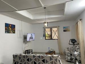 a living room with a couch and a window at Lege Bonoua in Bonoua