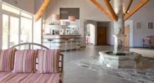 a living room with a couch and a fountain at Hotel Du Village Catalan in Banyuls-dels-Aspres