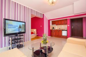 a living room with a couch and a tv at Apartament Margarites in Władysławowo