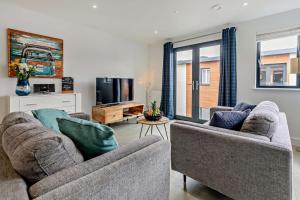 a living room with two couches and a tv at 2 Bed in Woolacombe oc-s29469 in Woolacombe