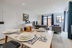 a living room with a table with plates and glasses at 2 Bed in Woolacombe oc-s29469 in Woolacombe