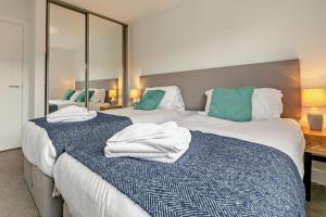two beds with towels on them in a bedroom at 2 Bed in Woolacombe oc-s29469 in Woolacombe +20 photos