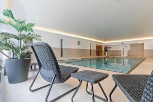 a house with a swimming pool and two chairs and a plant at 2 Bed in Woolacombe oc-s29469 in Woolacombe