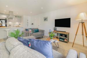 a living room with a couch and a flat screen tv at 2 Bed in Woolacombe oc-c29467 in Woolacombe