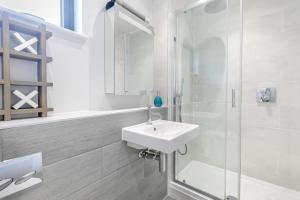 a white bathroom with a sink and a shower at 2 Bed in Woolacombe oc-c29467 in Woolacombe +16 photos