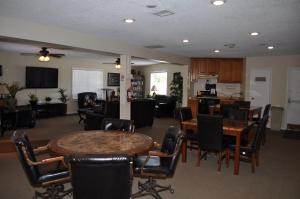 a living room with tables and chairs and a kitchen at Las Vegas Camping Resort Cabin 5 in Las Vegas