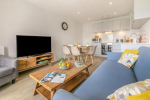 a living room with a blue couch and a table at 3 Bed in Woolacombe oc-t29466 in Woolacombe
