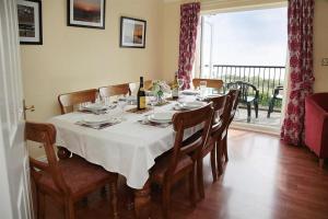 a dining room table with a white table cloth on it at 4 Bed in Port Eynon oc-hh9901 in Port-Eynon