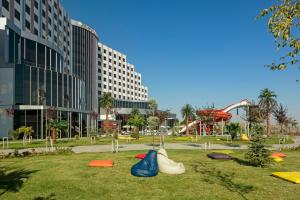 a playground in a park with a roller coaster at Grannos Thermal Hotel & Convention Center in Haymana