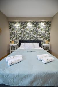 un grande letto con due cuscini bianchi sopra di Sun & Garden House a Oświęcim