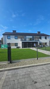 una recinzione di fronte a una casa con un edificio di Sun & Garden House a Oświęcim