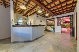 an open kitchen with a large island in a house at Hotel Pozo Rey by Youroom in Chipiona