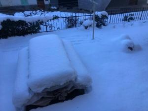 a pile of snow on a bench in a yard at Casa Bisalta relax in San Bartolomeo