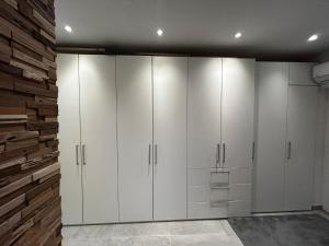 a room with white cabinets and a brick wall at Saras Weinchalet in Guntersblum