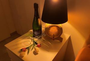 a bottle of champagne and a lamp on a table at Saras Weinchalet in Guntersblum