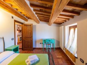 a bedroom with a bed and a table in a room at Apartment in a farmhouse with 2 swimming pools in Cagli