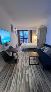 a room with a bed and a desk with a computer at Gudauri Loft Apartment N508 in Kʼumlistsʼikhe