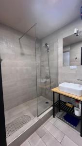 a bathroom with a shower and a sink at Gudauri Loft Apartment N508 in Kʼumlistsʼikhe +16 photos