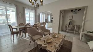 a living room with a table and a dining room at Vista Mare Sliema in Sliema