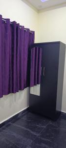 a door with purple curtains in a room at Sivakumar paradise in Mahabalipuram