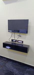 a flat screen tv on top of a wall at Sivakumar paradise in Mahabalipuram