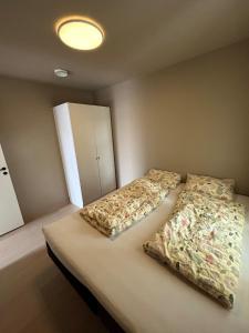 a bedroom with a bed with two pillows on it at Sentral leilighet in Egersund
