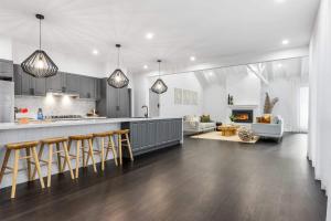 eine Küche und ein Wohnzimmer mit einer Theke und Stühlen in der Unterkunft Homestead on Fennell - Fresh Eggs, Farm & BBQ Fun in Toronto