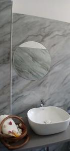 a bathroom with a white sink and a mirror at Jagir villa in Udaipur +11 photos