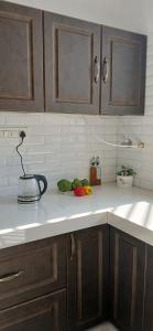 a kitchen counter with a sink and vegetables on it at Jagir villa in Udaipur