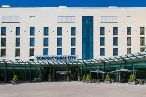 a large building with a sign that readssample owl city at Scandic Oulu City in Oulu