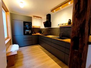 a kitchen with a sink and a stove top oven at Bergstadthaus Sankt Andreasberg für Familien und Freunde in Sankt Andreasberg