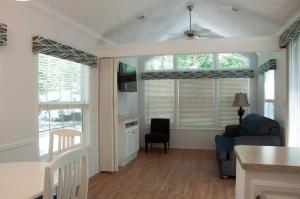 a living room with a couch and a table at Sea Pines Loft Cottage 7 in Swainton