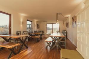 a dining room with wooden tables and benches at Harz BnB Werkmeister in Sankt Andreasberg